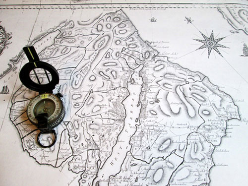 photograph of an old map with a compass.