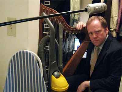 photograph of Scott in a closet with his harp